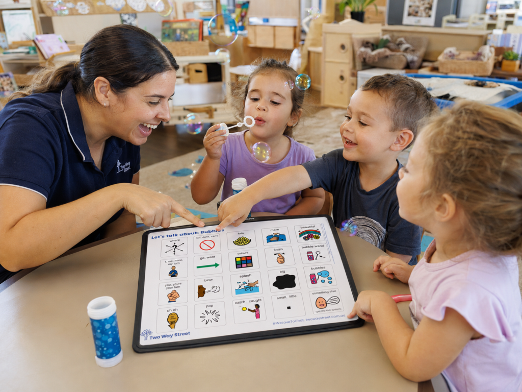 Using an AAC communication board to blow bubbles in an early learning classroom